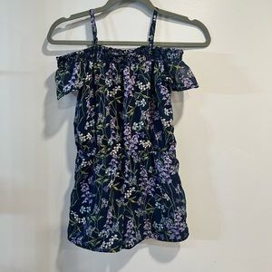 Navy floral pattern short romper with straps and off the shoulder short sleeves.